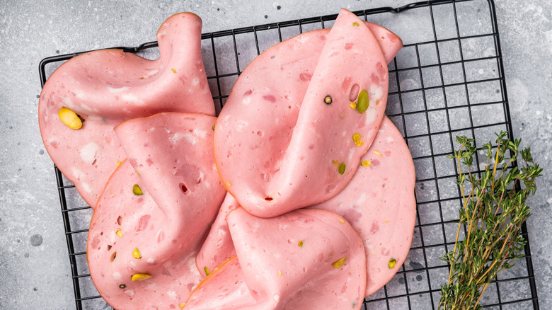 slices of bologna on a steel rack