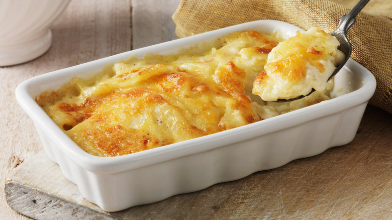A white ceramic dish of au gratin potatoes