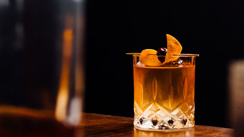 Old Fashioned with orange peel and cherry garnish