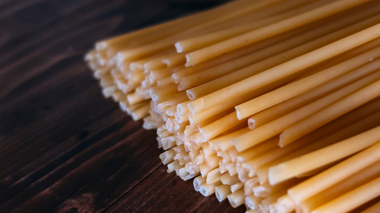 A stack of dried bucatini, showing the holes in their ends
