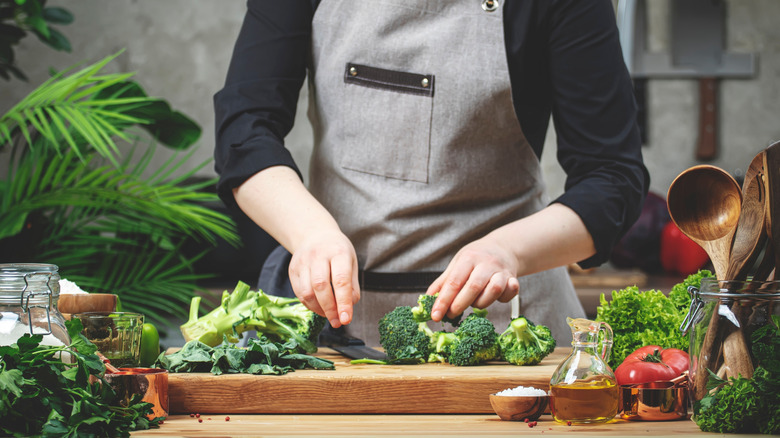 Chef holding chopped broccoli florets