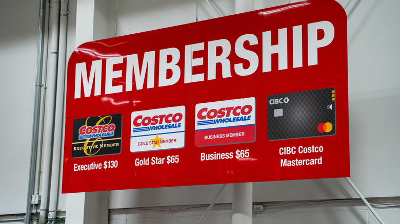 Costco membership sign with membership options listed.