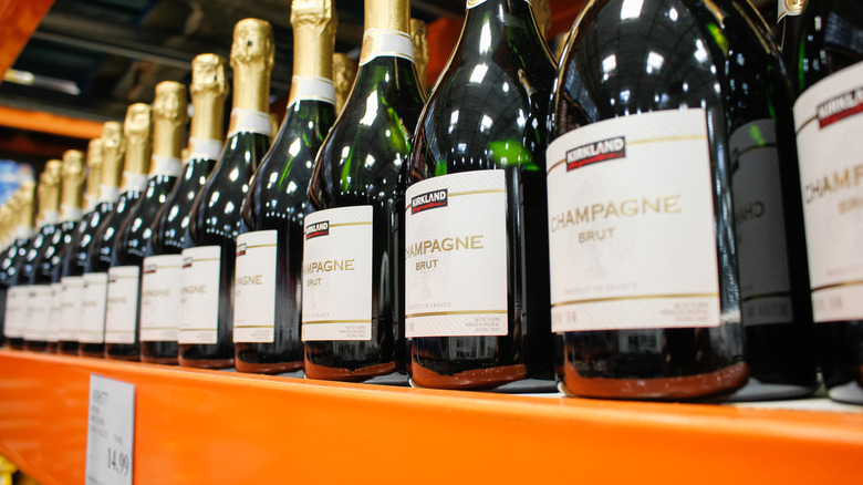 Bottles of Kirkland Champagne Brut on a Costco shelf