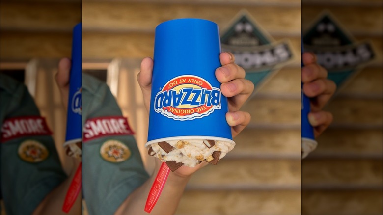 A hand holding an upside down Blizzard from Dairy Queen.
