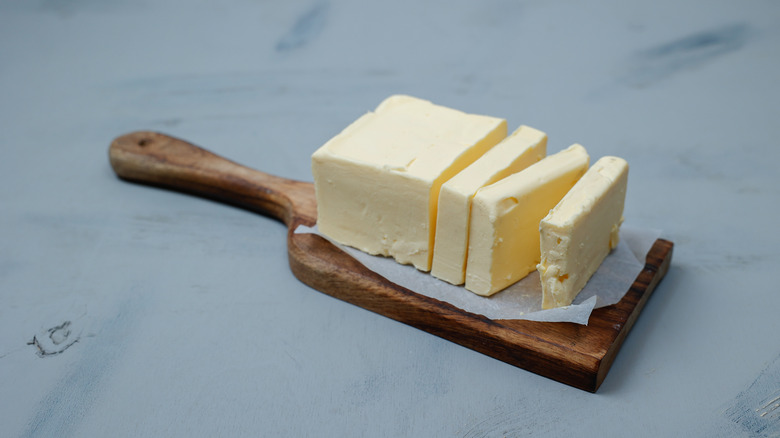Sliced pieces of butter on a light table, selective focus. Piece of butter.
