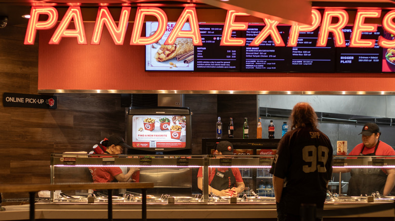 Workers prepare a customer's order at a Panda Express restaurant
