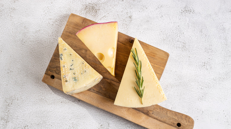 Cheese wedges on a wooden board
