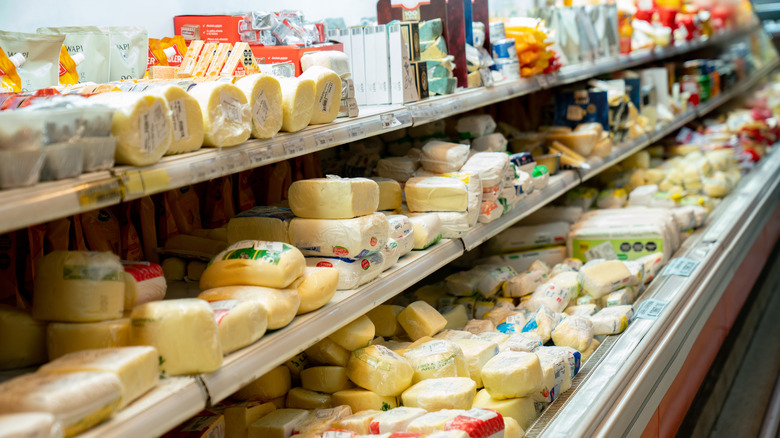 Grocery store shelves of cheese