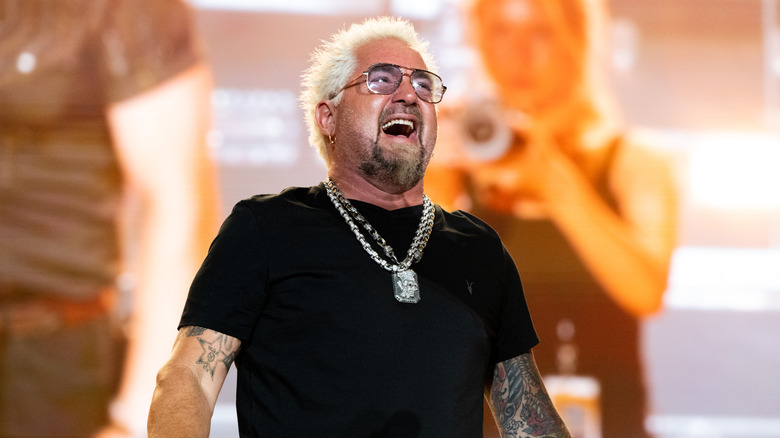 Guy Fieri with open mouth in front of photographer