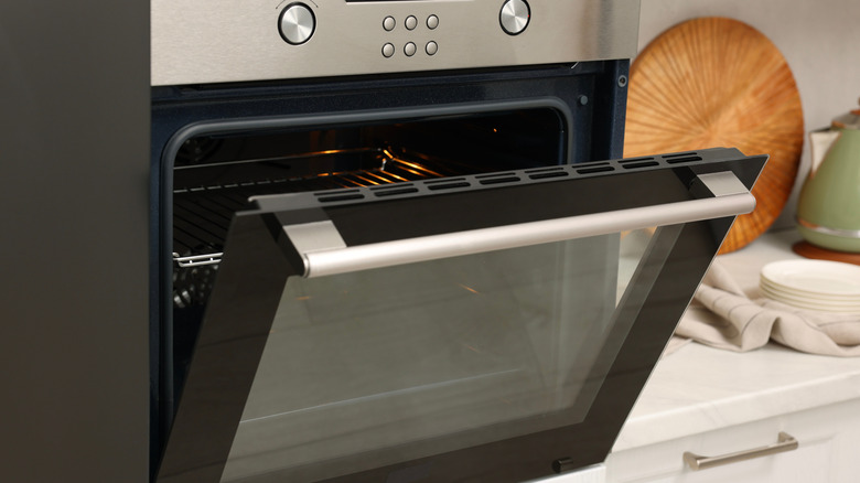 An open electric oven in a kitchen.