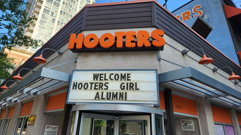 The Hooters sign with 'welcome hooters girl alumni' below it