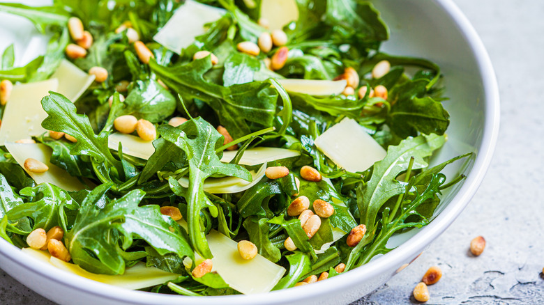 Pine nuts on an arugula and parmesan salad