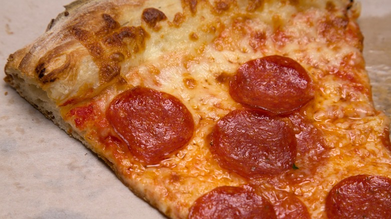 Pizza on greasy cardboard.