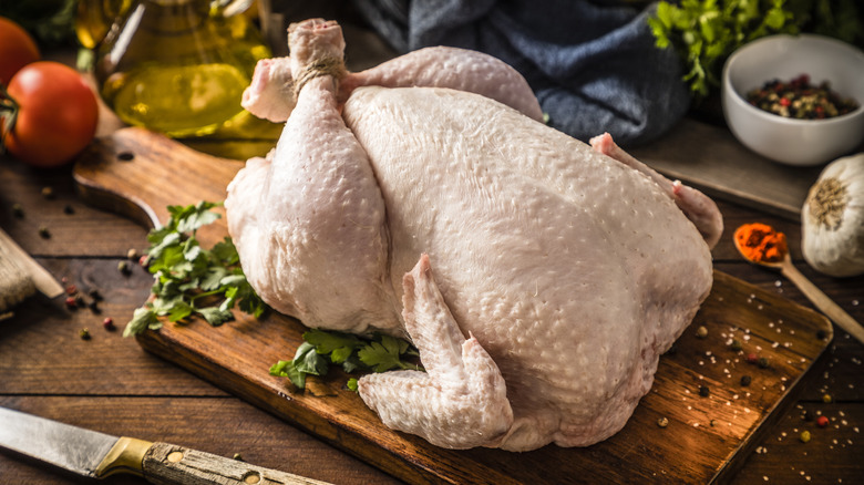 Raw chicken on cutting board
