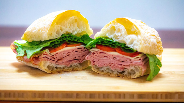 Bologna sandwich with cheese, lettuce, and tomato