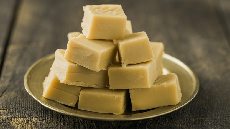 A plate of fudge on a wooden table.