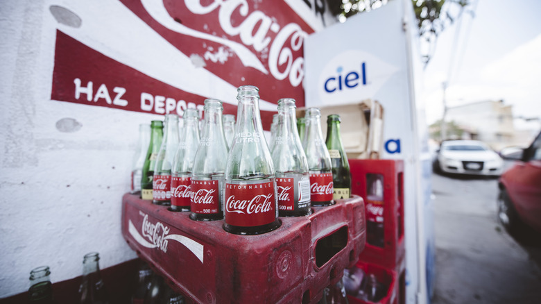 Glass bottles of Mexican coke next to a truck