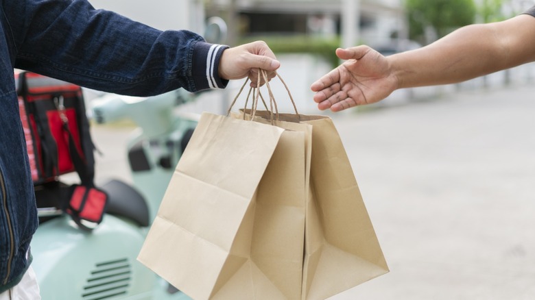 two paper bags of food being delivered