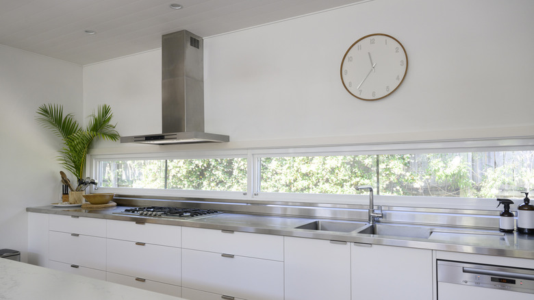 statement clock hung above kitchen sink