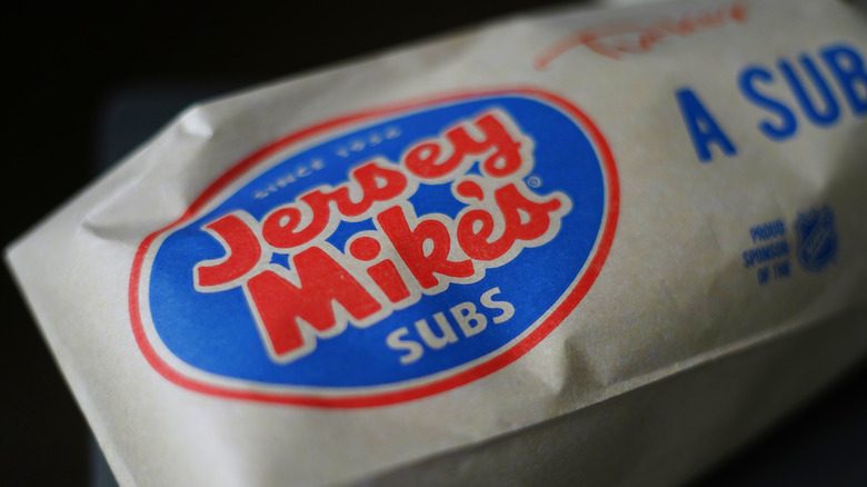 A Jersey Mike's sub sandwich wrapped in branded paper
