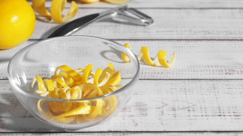 lemon peels in glass bowl on table
