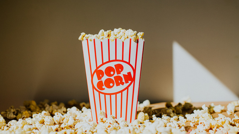 A box of movie theater popcorn sitting on a table.