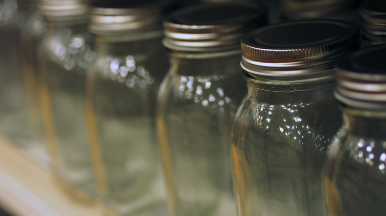 a close-up shot of a row of empty Mason jars