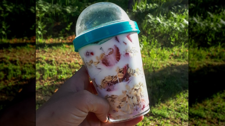 Overnight oats in a portable plastic container with dual compartments