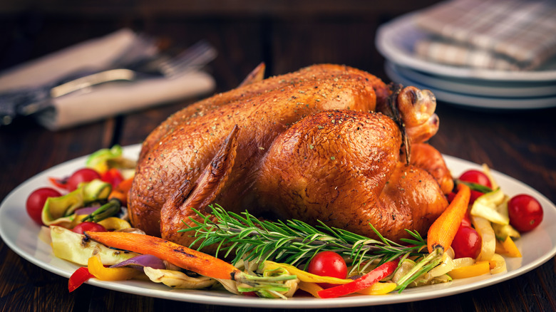 roast chicken on platter with veggies
