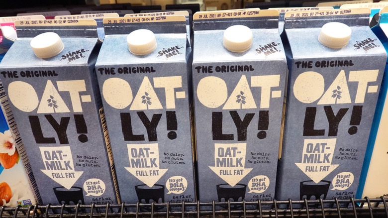 Oat milk cartons stacked on a supermarket shelf