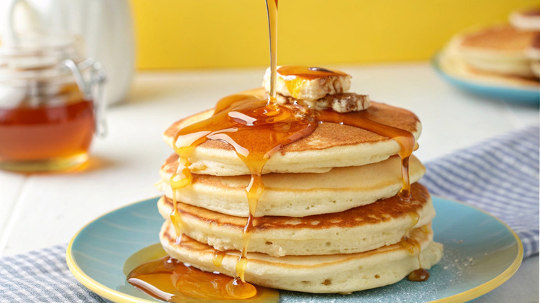 Syrup flowing down a fluffy pancake stack