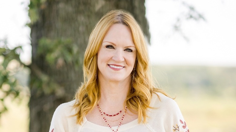 Ree Drummond in white shirt in front of tree