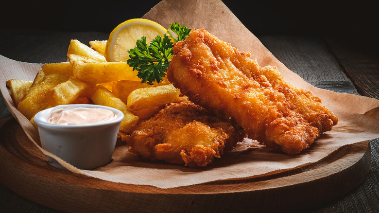Fish and chips on wooden plate