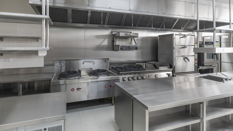 Professional kitchen with multiple heat sources and hoods for ventilation