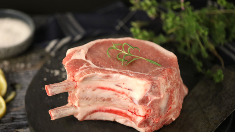 An extremely thick, raw pork chop