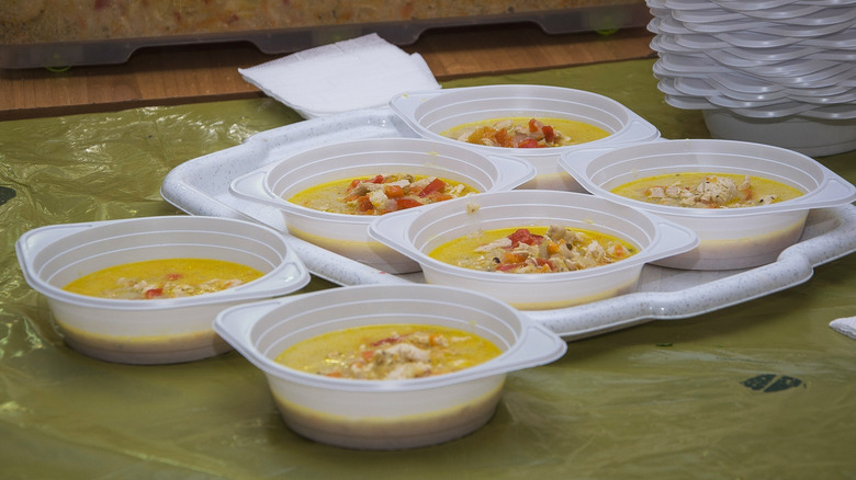 Bowls of soup portioned out into plastic containers