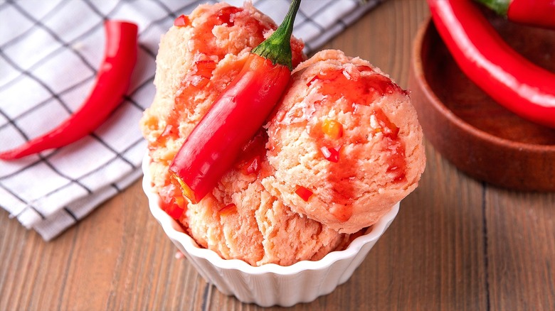 Bowl of red chili ice cream with hot sauce
