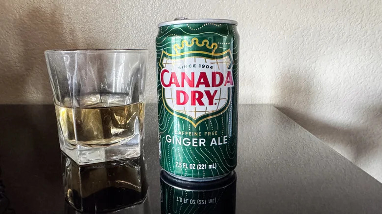 Can of Canada Dry ginger ale next to a glass of it