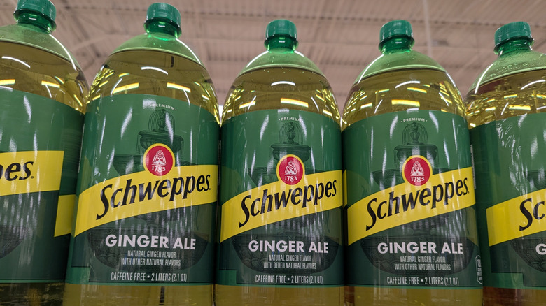 Two-liter bottles of Schweppes ginger ale on a store shelf