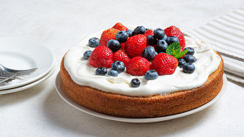 Single layer cake with whipped cream and berries