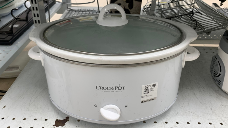 Crockpot slow cooker on a shelf in a thrift store