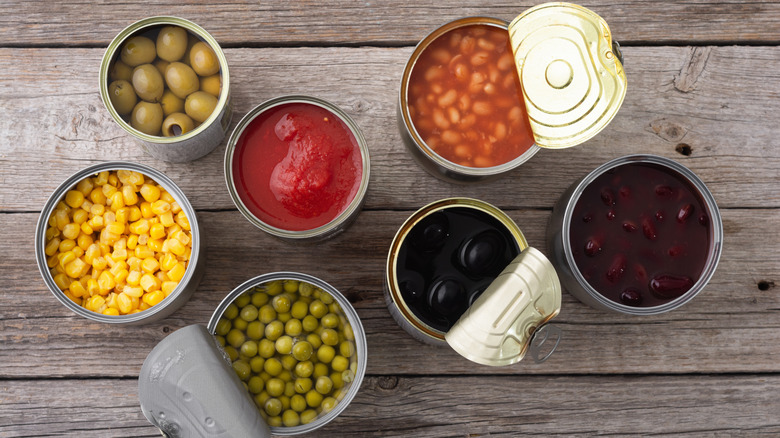 Variety Canned vegetables sit on a wooden background