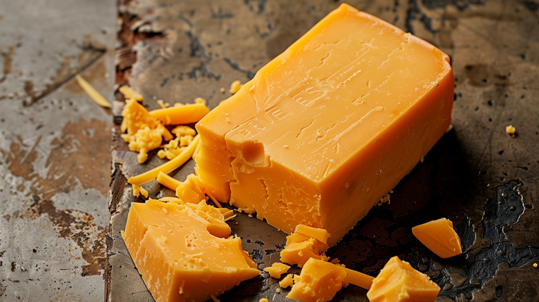 A block of cheddar cheese on the counter