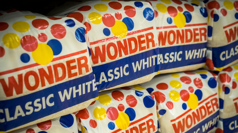 Loaves of Wonder Bread Classic White stacked at the grocery store.