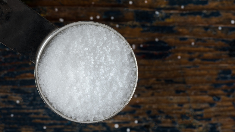 Close-up of salt in a metal measuring spoon