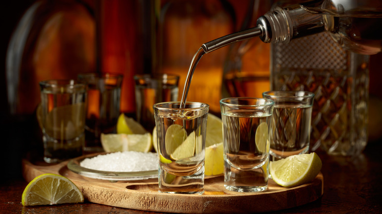 Tequila being poured into a shot glass
