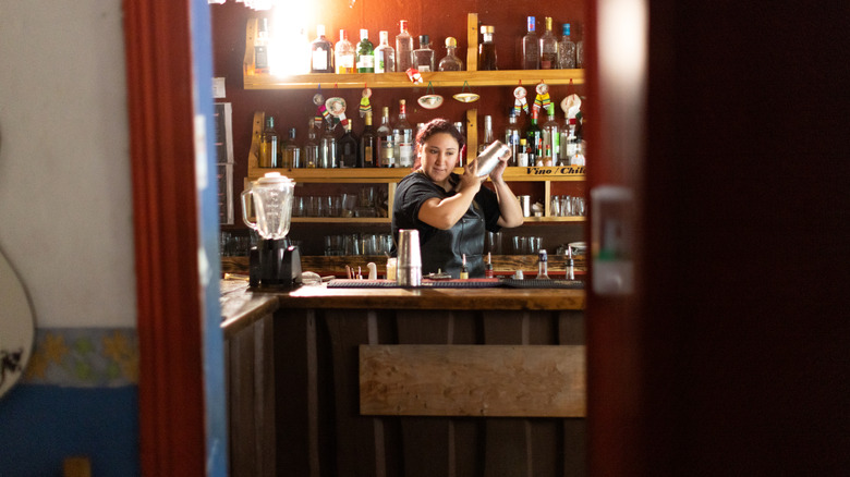 A bartender mixing drinks behind the bar