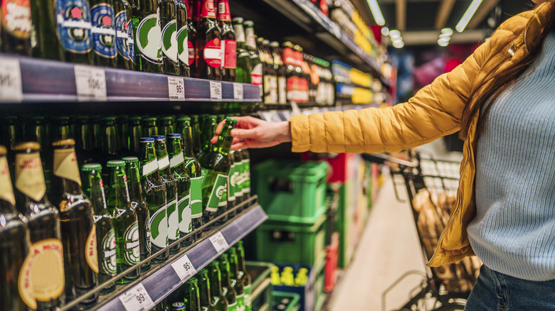 Person taking beer off shelf