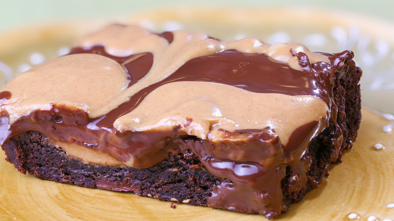 Fudgy brownie topped with peanut butter and chocolate frosting