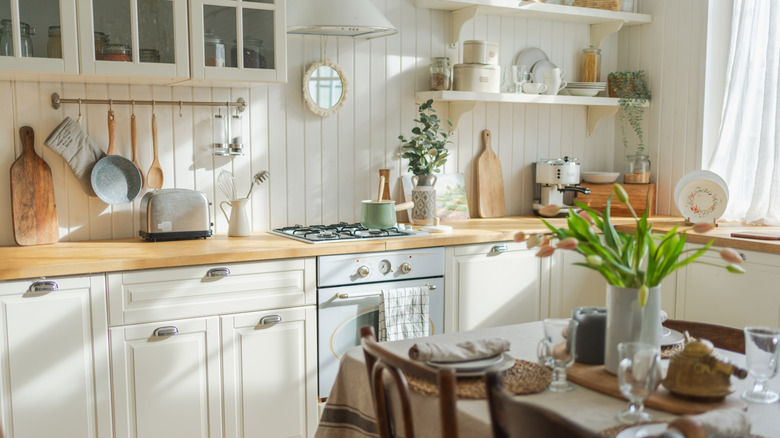 A cozy kitchen design with white cabinets.